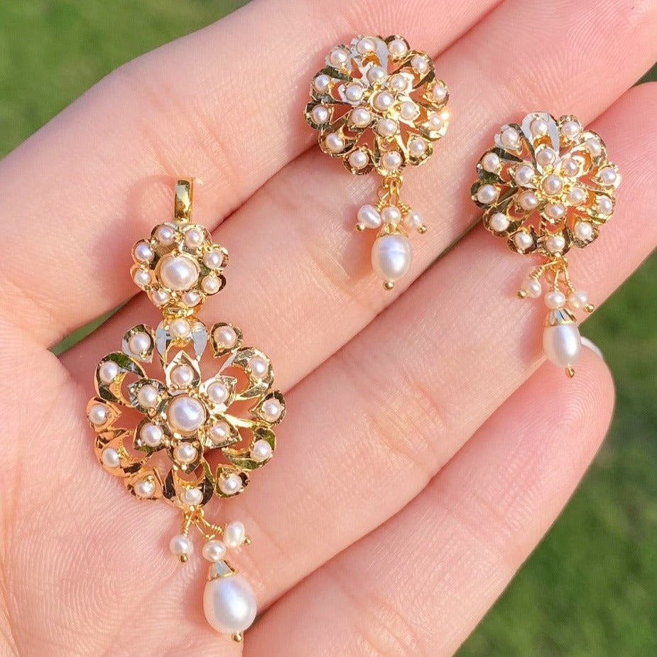dainty gold pendant set with pearls