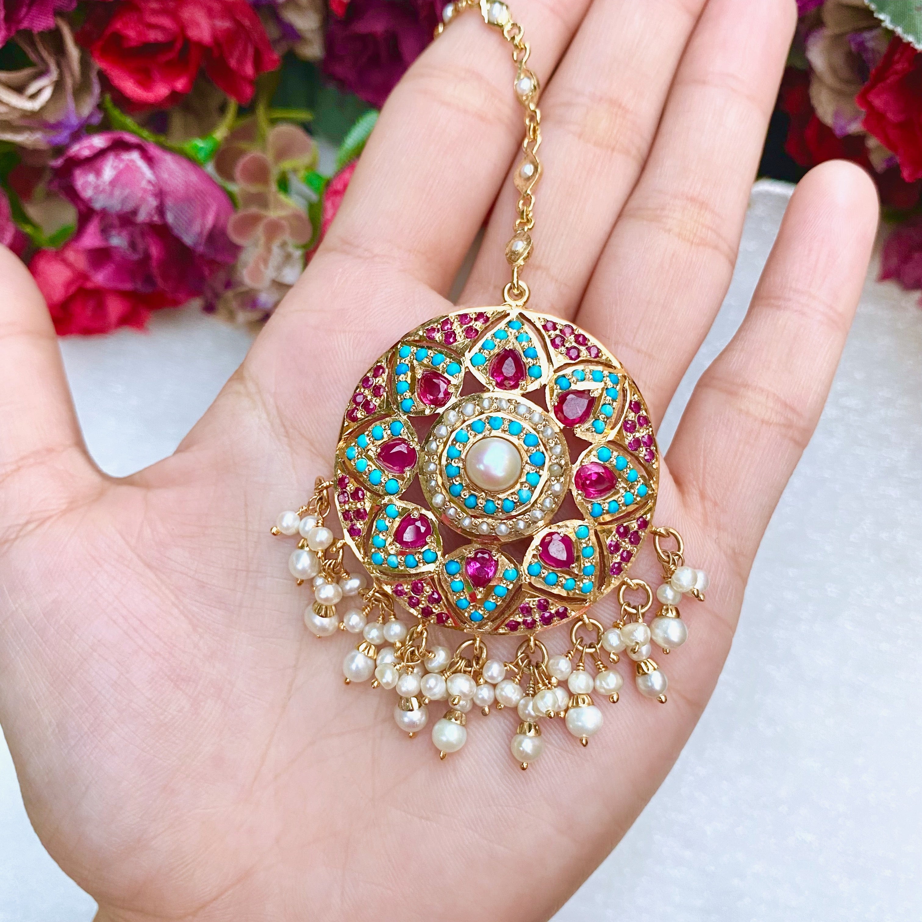 round maang teeka studded with pearls, rubies and pheroza