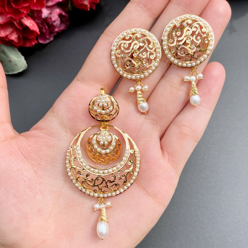 gold pendant set studded with pearls