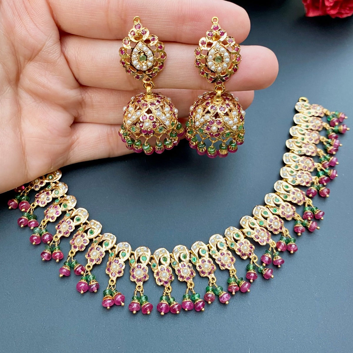 delicate gold necklace set studded with precious stones