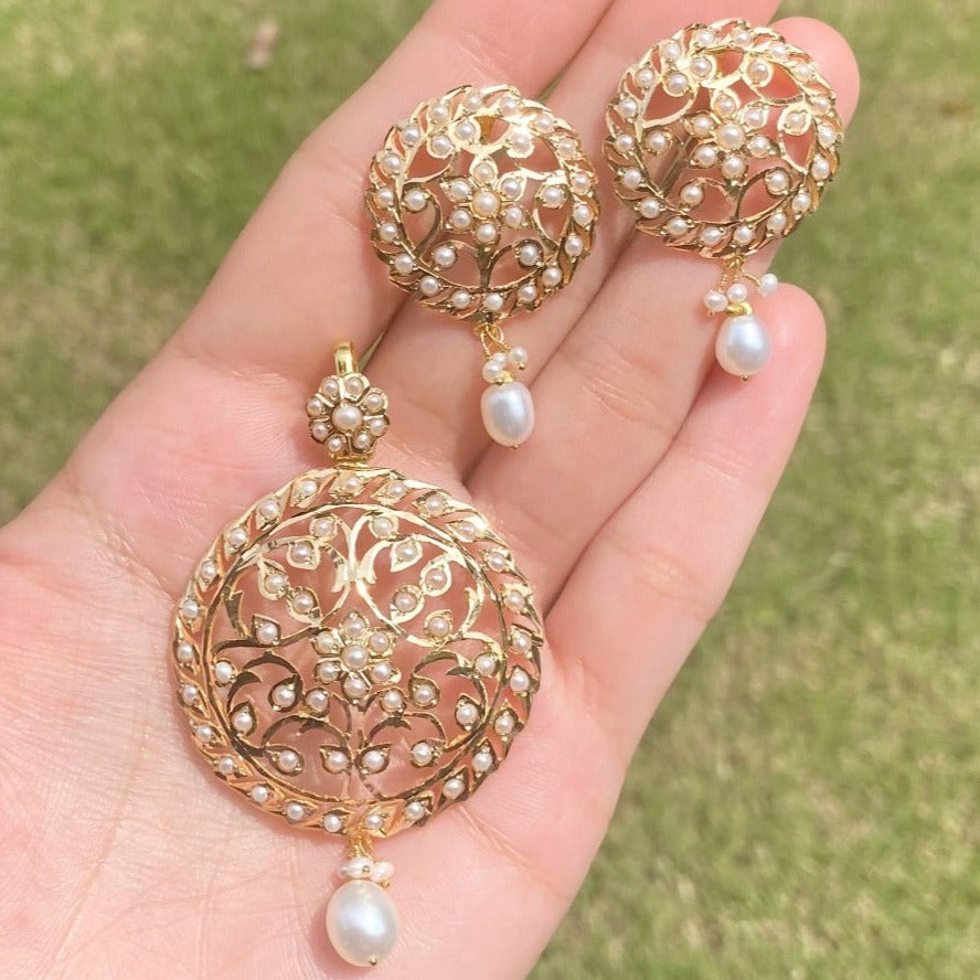 gold pendant set studded with freshwater pearls