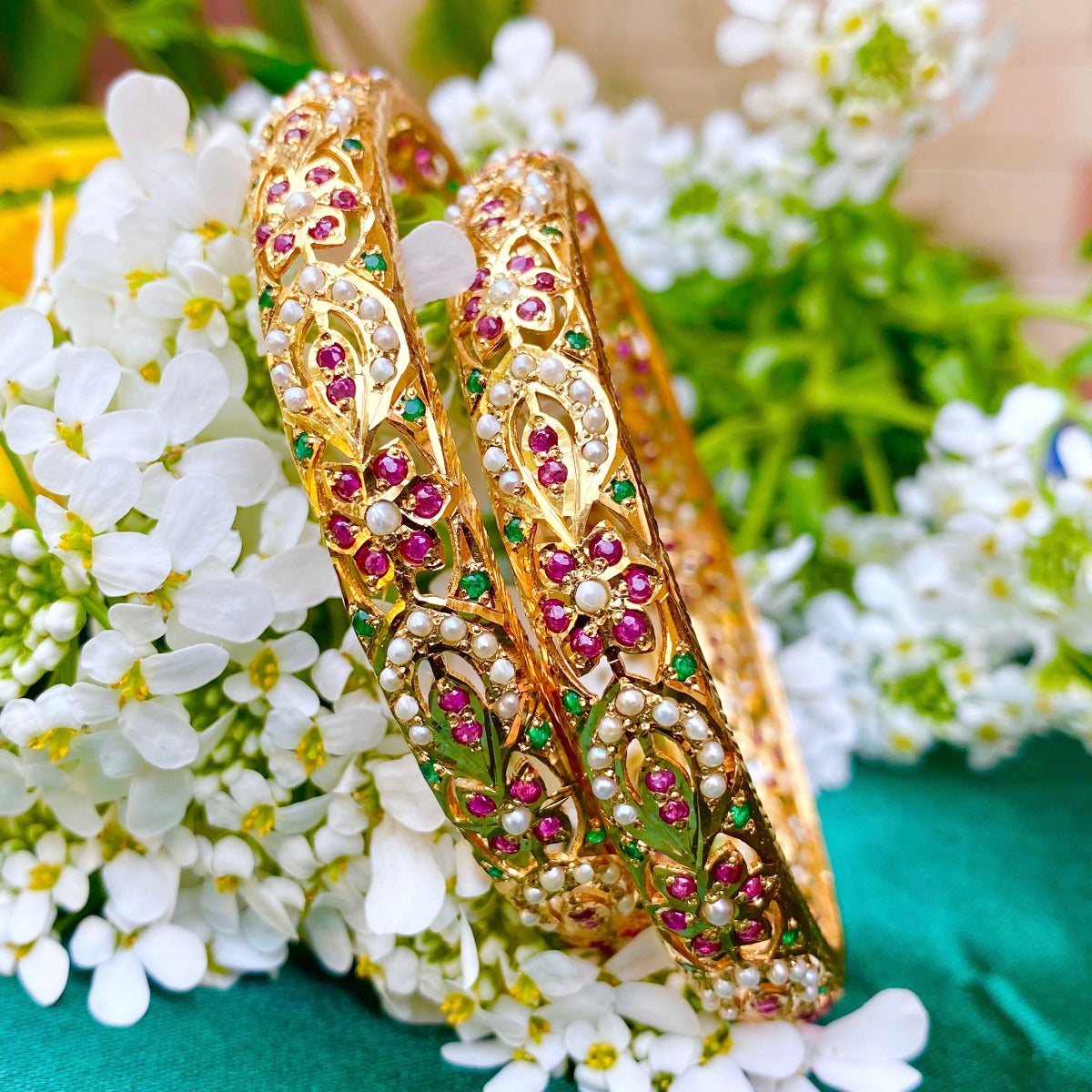 pair of jadau bangles in gold polished silver